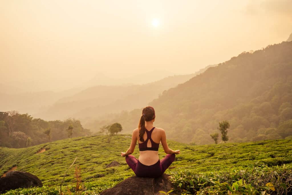 woman relaxing on the top of a mountain