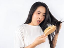 A woman shocked to see hair loss