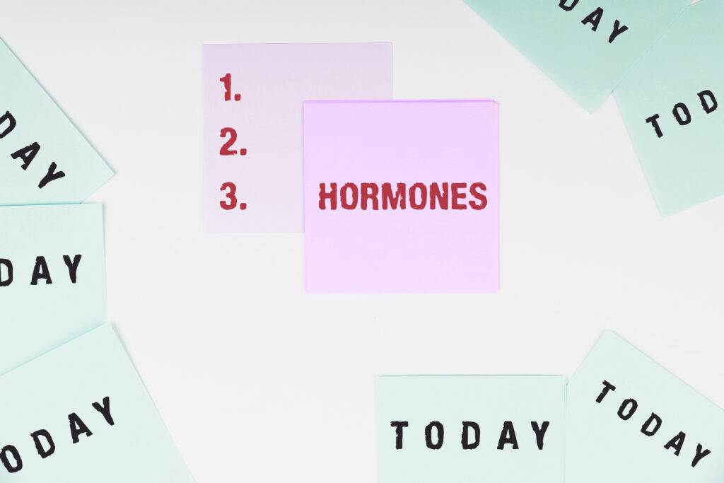 Sticky notes on a white background, with one pink note reading "HORMONES" and another showing a numbered list (1, 2, 3), surrounded by light green notes labeled "TODAY".