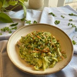 Healthy vegetable salad with herbs on ceramic plate, colourful, fresh ingredients, rustic charm, natural light.