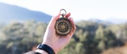 hand holding a compass