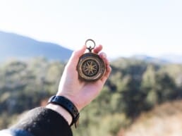 hand holding a compass